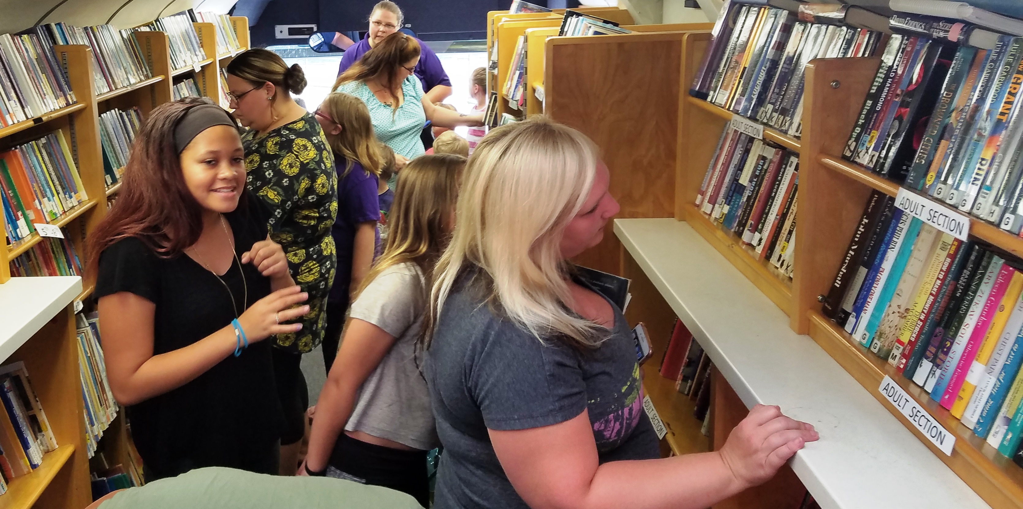 Families board the bus looking for books to start off the school year!